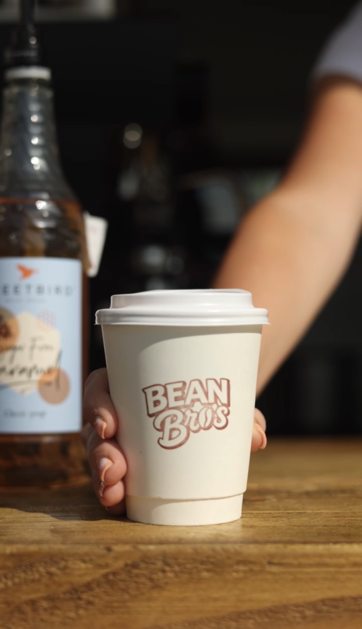 A Bean Bros coffee served in a branded cup